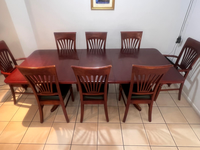 9 piece dark red/mahogany dining table with olive leather chairs. In good condition. It has 2 armchairs...