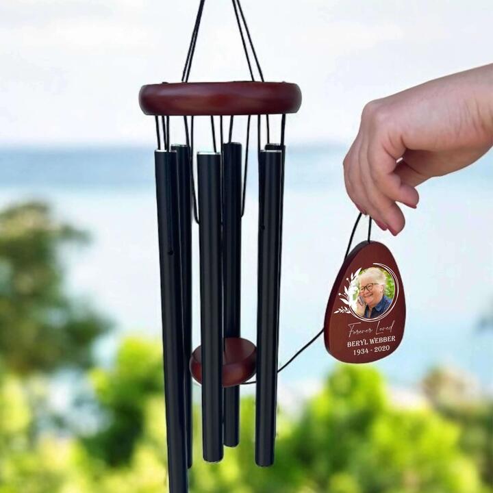 Let their memory ring softly on the breeze with this beautifully personalised memorial photo wind...