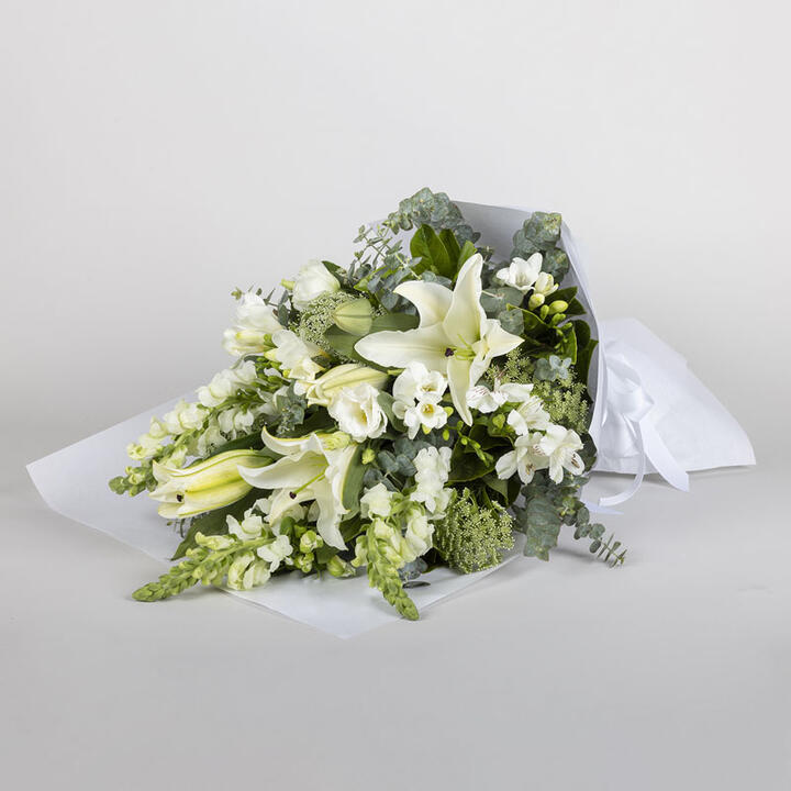 The “Heavenly Lilies” Bouquet is a beautiful arrangement that conveys heartfelt condolences and...