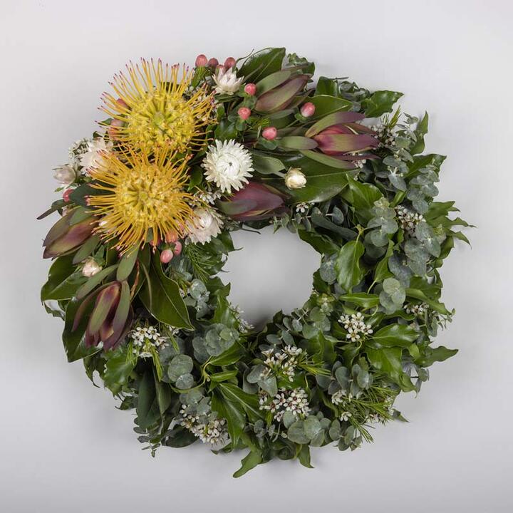This beautiful funeral wreath features a stunning combination of flowers and foliage to pay tribute to...