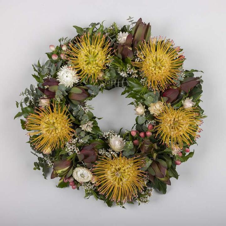 This exquisite funeral wreath is a heartfelt expression of remembrance and honour. It features an...