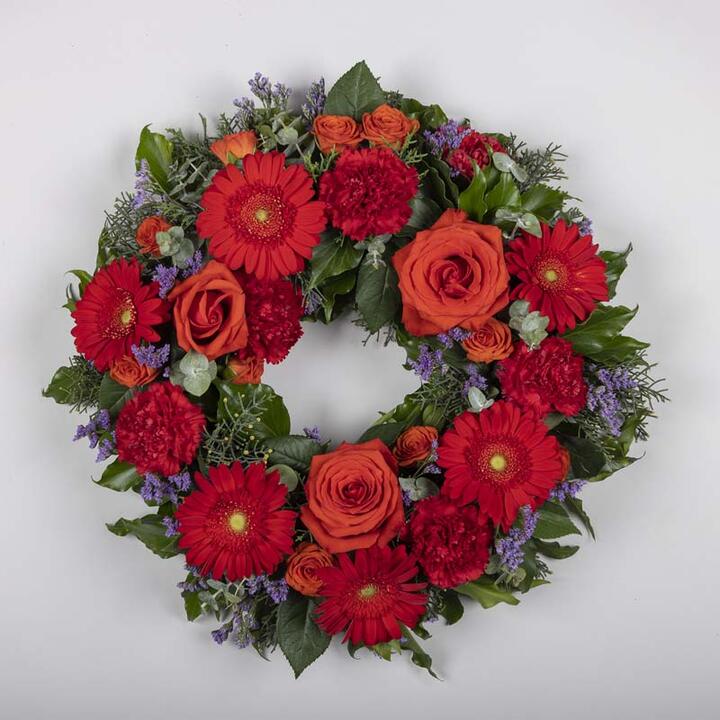 This stunning funeral wreath is a heartfelt expression of eternal love and remembrance. It features a...
