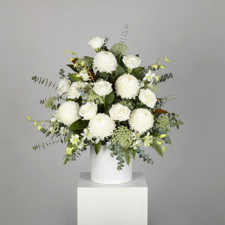 Simple Funeral Chapel Arrangement is a serene and dignified floral arrangement designed to offer a...