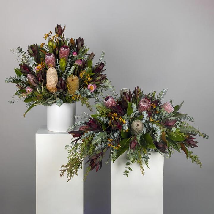Honour the memory of your loved one with the Native Funeral Flower Display, a reverent tribute ensemble...