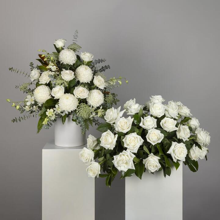 Embrace the tranquillity and purity of remembrance with the White Rose Funeral Display, a harmonious...