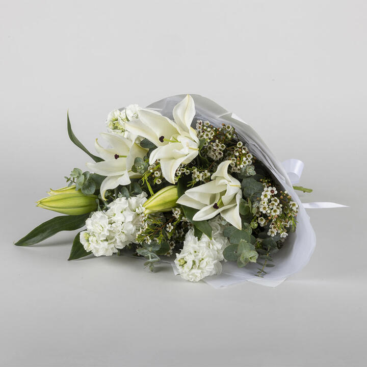 Simple and elegant, this white flower bouquet has stunning white oriental lilies, accompanied with...
