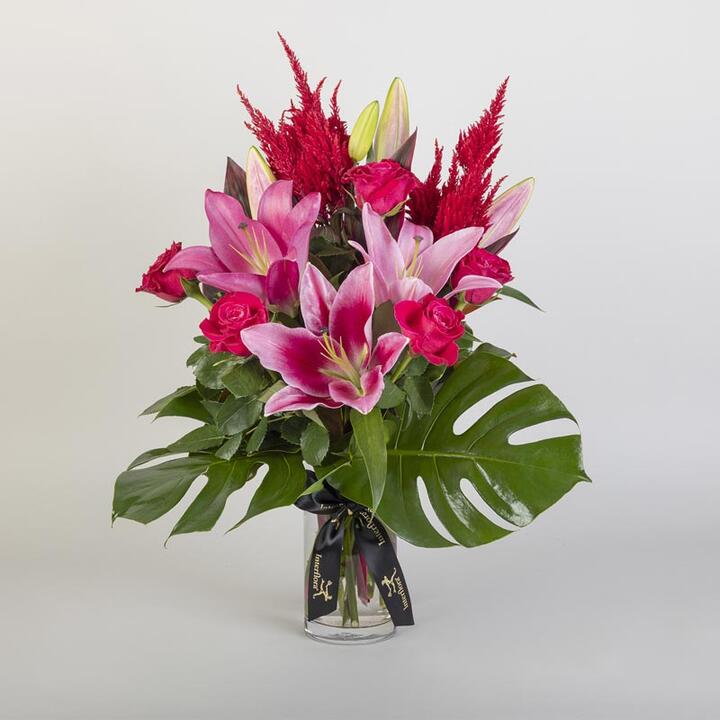 Elegant, modern and delivered in a glass vase, this vibrant flower bouquet of pink lilies and pink...