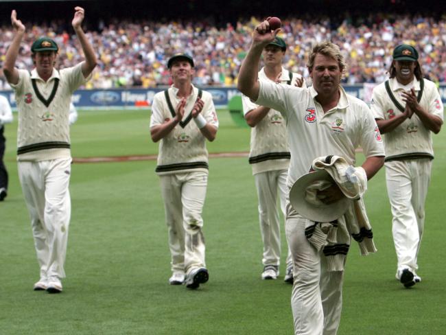 Shane Warne is cheered from the MCG as he holds the ball aloft to celebrate taking five wickets in the innings as well as his 700th wicket during the 2006 Boxing Day Test.