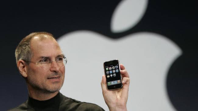 Apple CEO Steve Jobs holds up the new iPhone during his keynote address at MacWorld Conference &amp; Expo in San Francisco. Picture: Paul Sakuma
