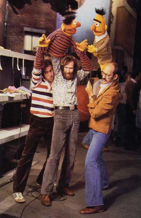 Jim Henson (centre) with Bert and Ernie puppets on Sesame Street.