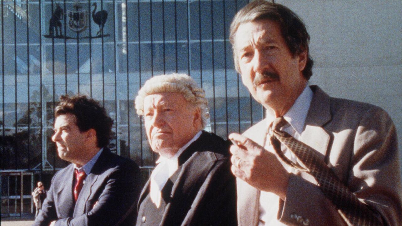 Tiriel Mora (as Dennis Denuto), Charles 'Bud' Tingwell (Lawrence Hammill) and Michael Caton (Darryl Kerrigan) in a scene outside the High Court of Australia from the movie The Castle.	