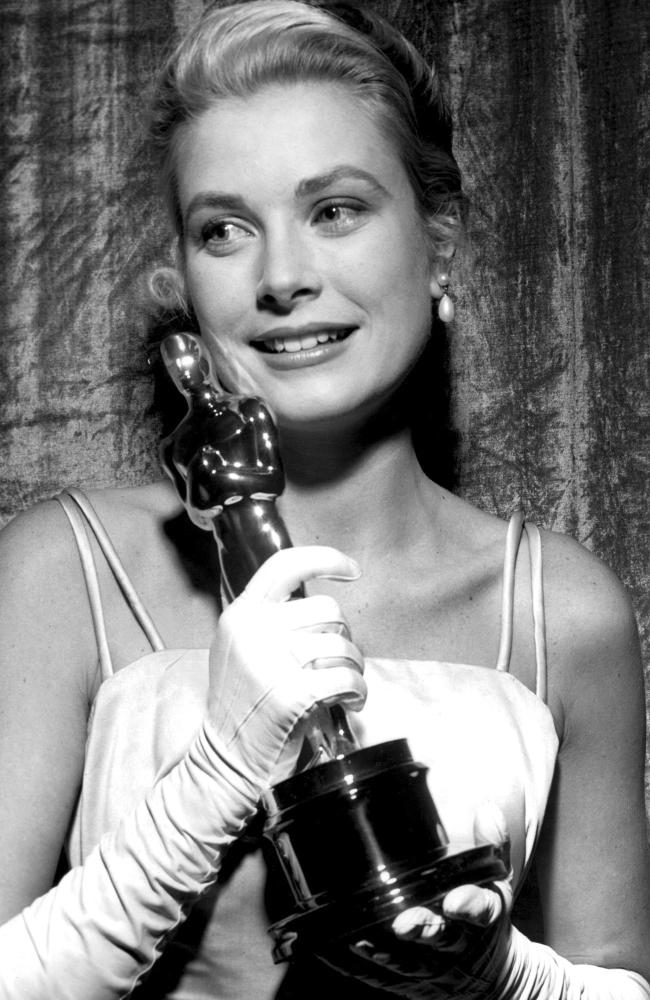 An emotional Grace Kelly holding her Best Actress Oscar.