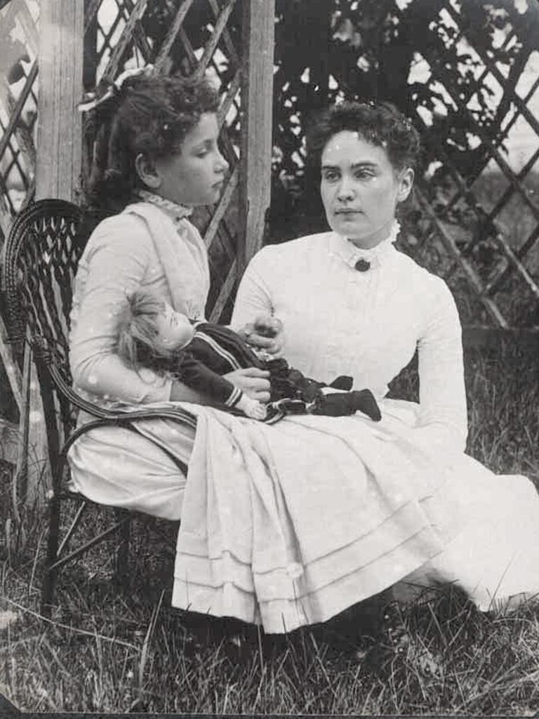 Deaf and blind author Helen Keller, holding a doll when she was eight-years-old, is seen with her devoted teacher Ann Sullivan in 1888. Picture: New England Historic Genealogical Society
