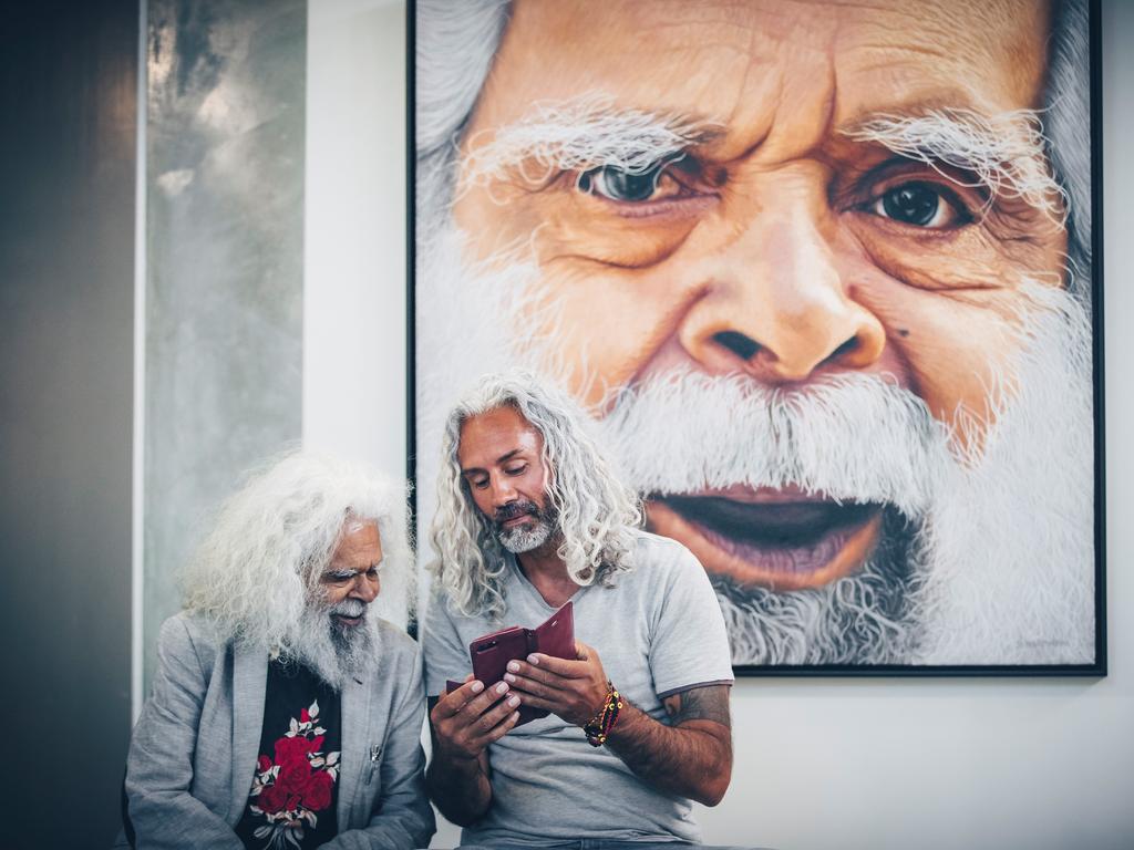 Uncle Jack Charles with blood relation Jandamarra Cadd's painting entitled Cleverman that won the 2019 Sunshine Coast Art Prize People’s Choice award. Image: ben vos productions.