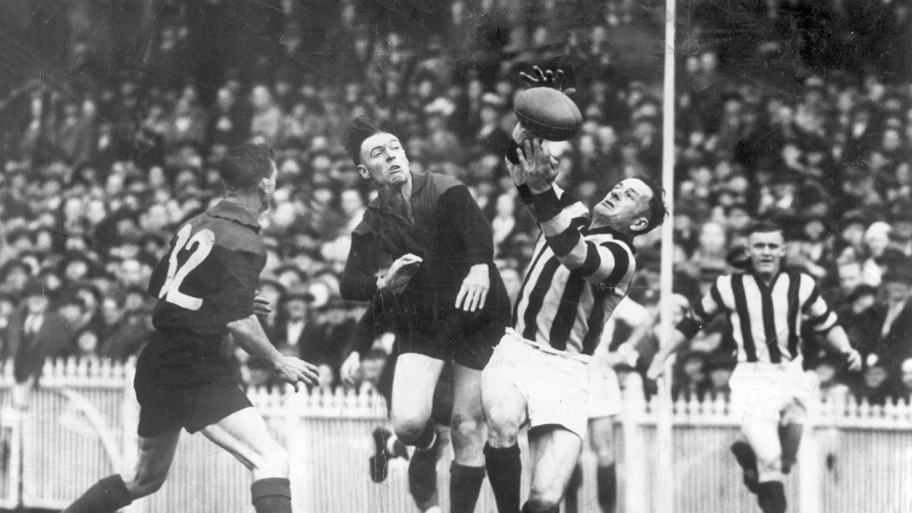 Collingwood legend Gordon Coventry marking the ball against Melbourne in 1937.