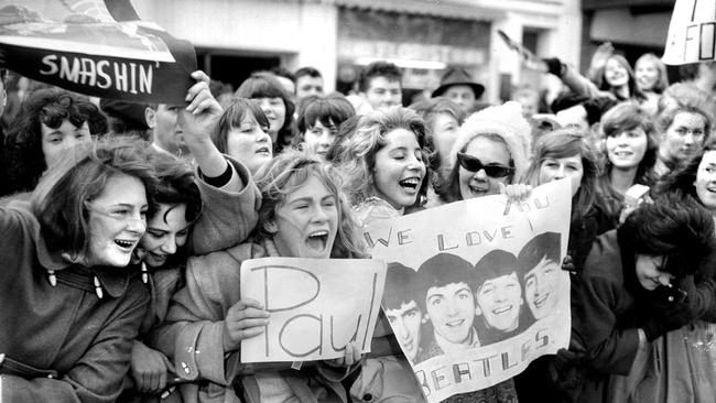 Adoring fans line Exhibition Street to see The Beatles during their tour of Melbourne. Picture: Bill Tindale, HWT Library
