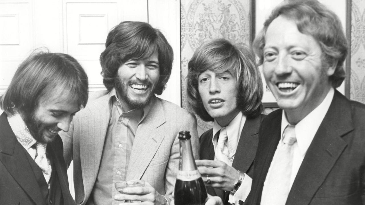 The Bee Gees celebrate their early success with manager Robert Stigwood in 1970. Picture: Supplied/ANL/Shutterstock