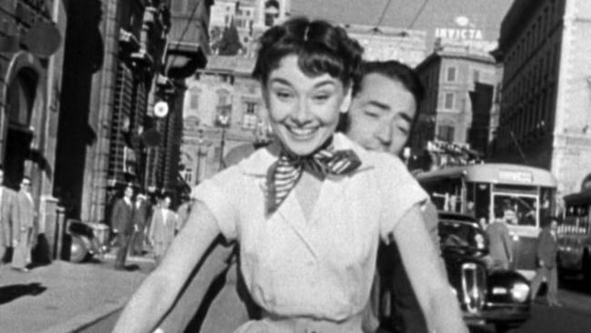 Audrey Hepburn as Princess Ann and Gregory Peck as Joe Bradley riding a Vespa in Roman Holiday (1953) 