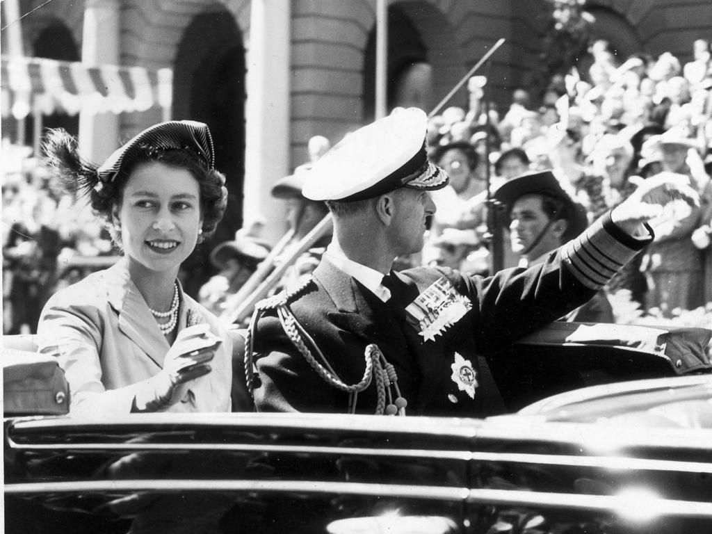Queen Elizabeth II with Prince Philip waves to crowds in Hobart during their Australian tour in 1954.