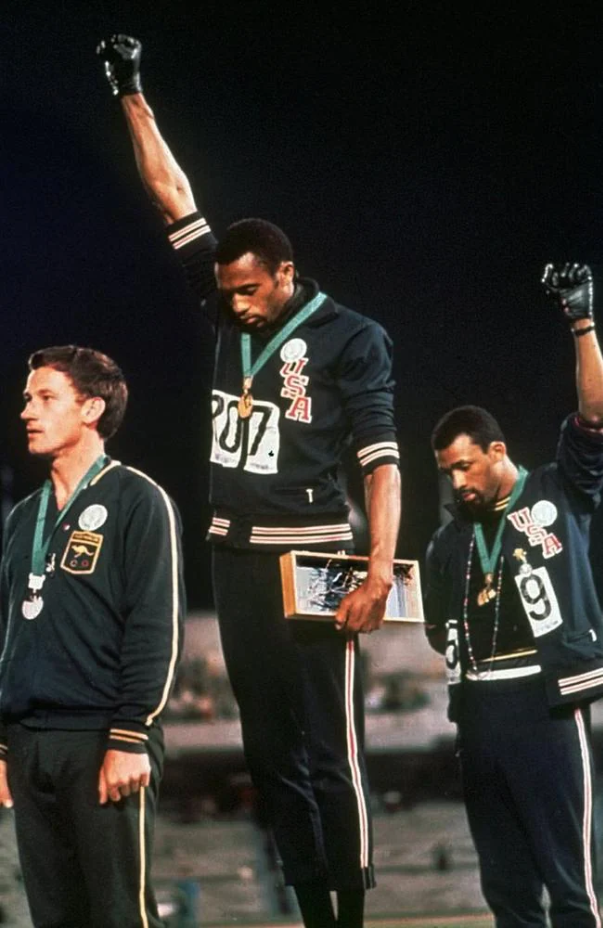  US athletes Tommie Smith (centre), and John Carlos make their famous salute alongside Australian Peter Norman at the 1968 Olympic Games.Source:Supplied