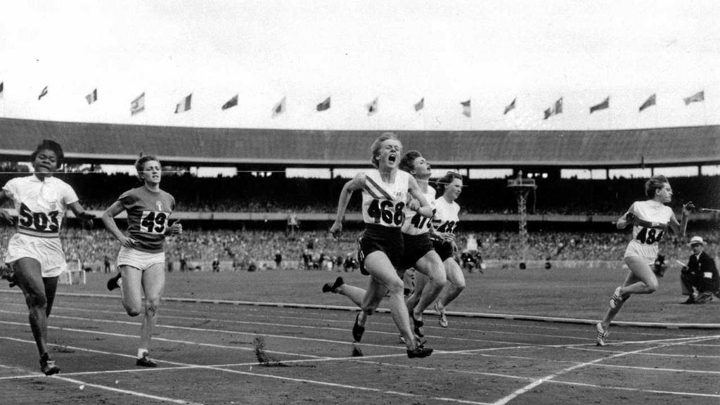 Betty Cuthbert of Australia (centre) runs past the finish line to win the women's 100m at the 1956 Summer Olympics.