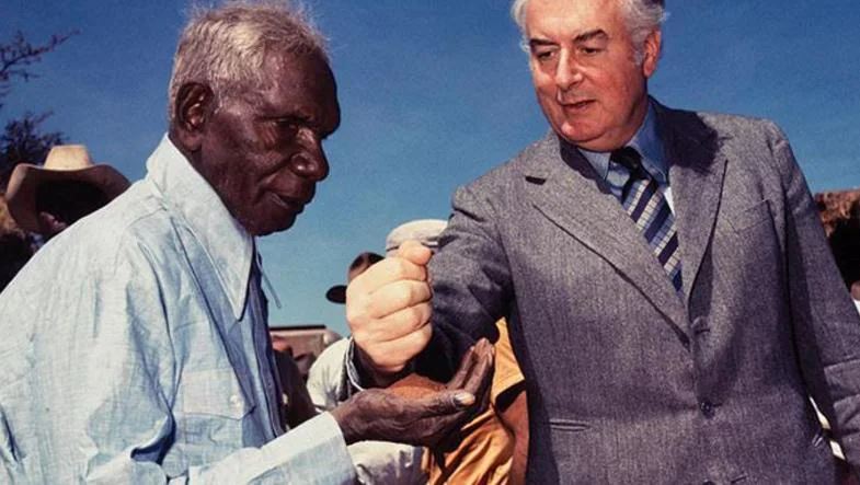 Gough Whitlam pouring soil into the hands of Vincent Lingiari in 1975. NT News | PICTURE: Merv Bishop
