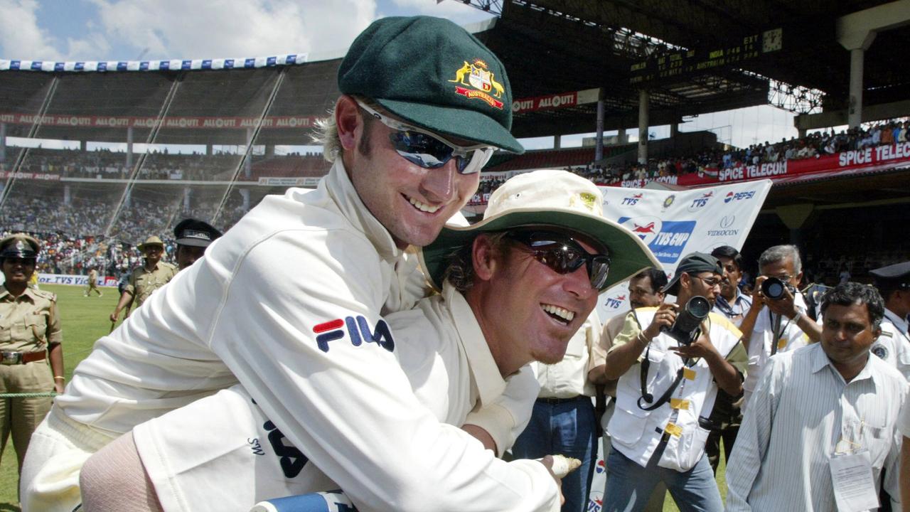 Shane Warne carries teammate Michael Clarke from field after Clarke's Man of the Match performance in their win over India in Bangalore, India 10/10/2004.