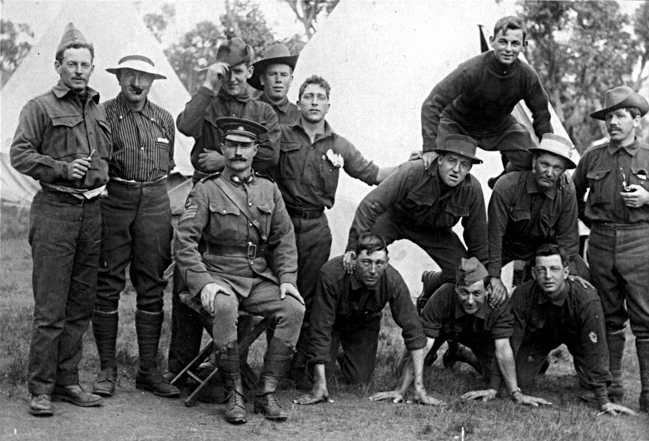 Informal group portrait of a section of the Australian 3rd Field Ambulance at Blackboy Hill, Western Australia, October 1914. Private John Simpson Kirkpatrick is standing third from left, behind the seated sergeant-major. Four of the thirteen men in the photo were killed during the Battle of Gallipoli.
