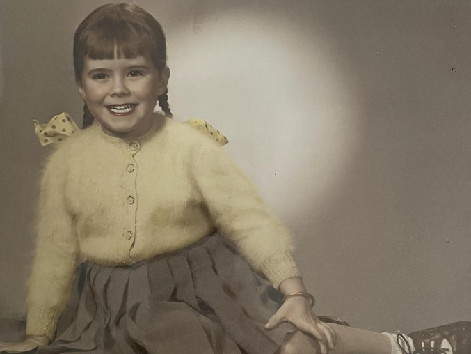 Glaswegian Jacqui Abercrombie as a child, showing off the beaming smile she would be known for all her life.