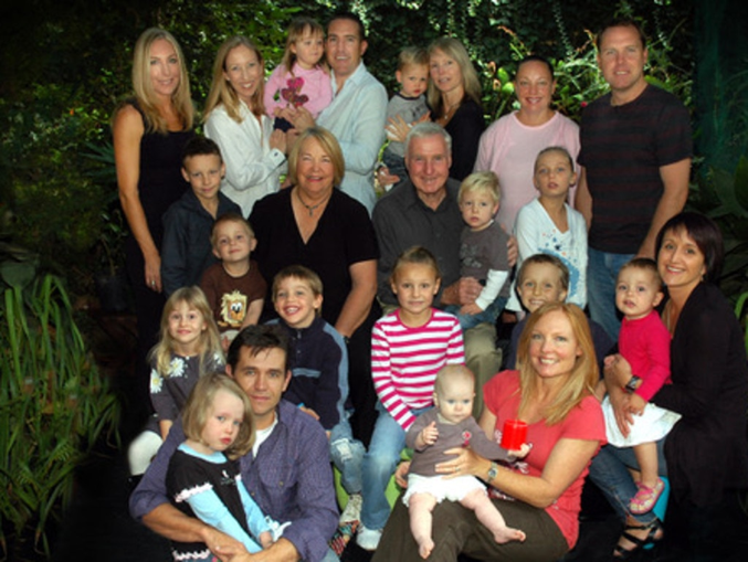 Family man … Rom pictured with his wife Val, their children and grandchildren.  

