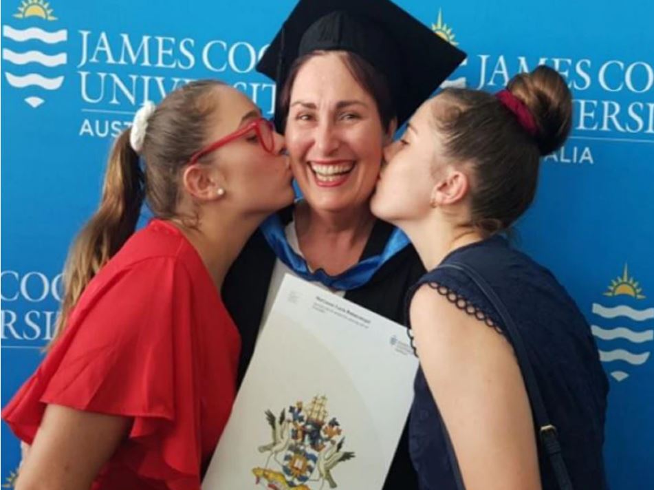 Daughters Eliza and Molly congratulate their mum Maryanne Balanzategui on her graduation.