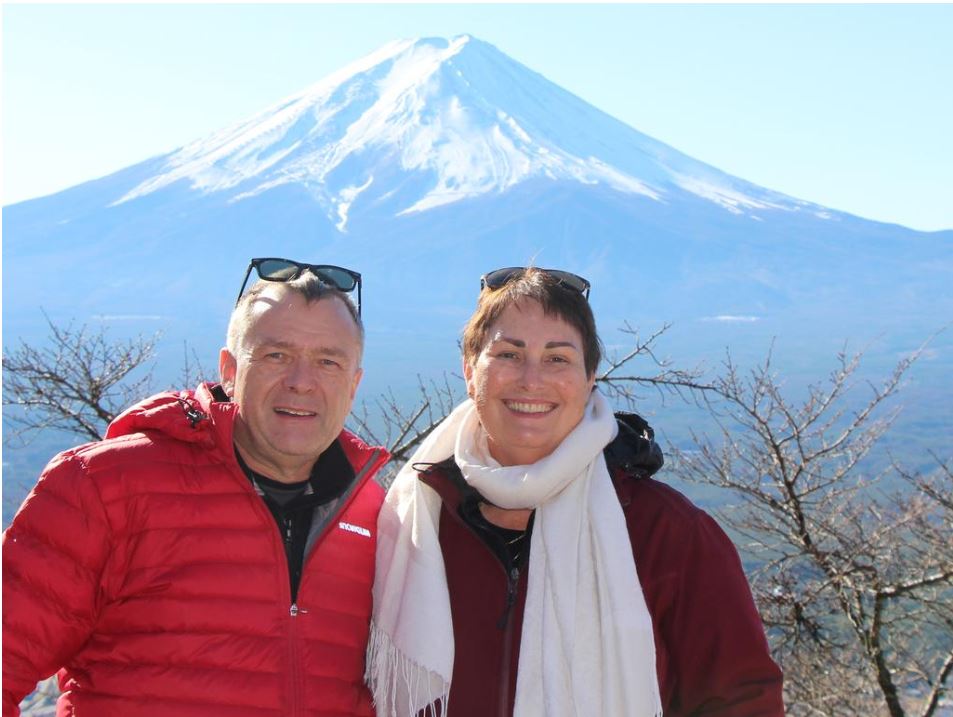 Andrew Gysberts and wife Maryanne Balanzategui, pictured at Mt Fuji, had travelled to 72 countries.
