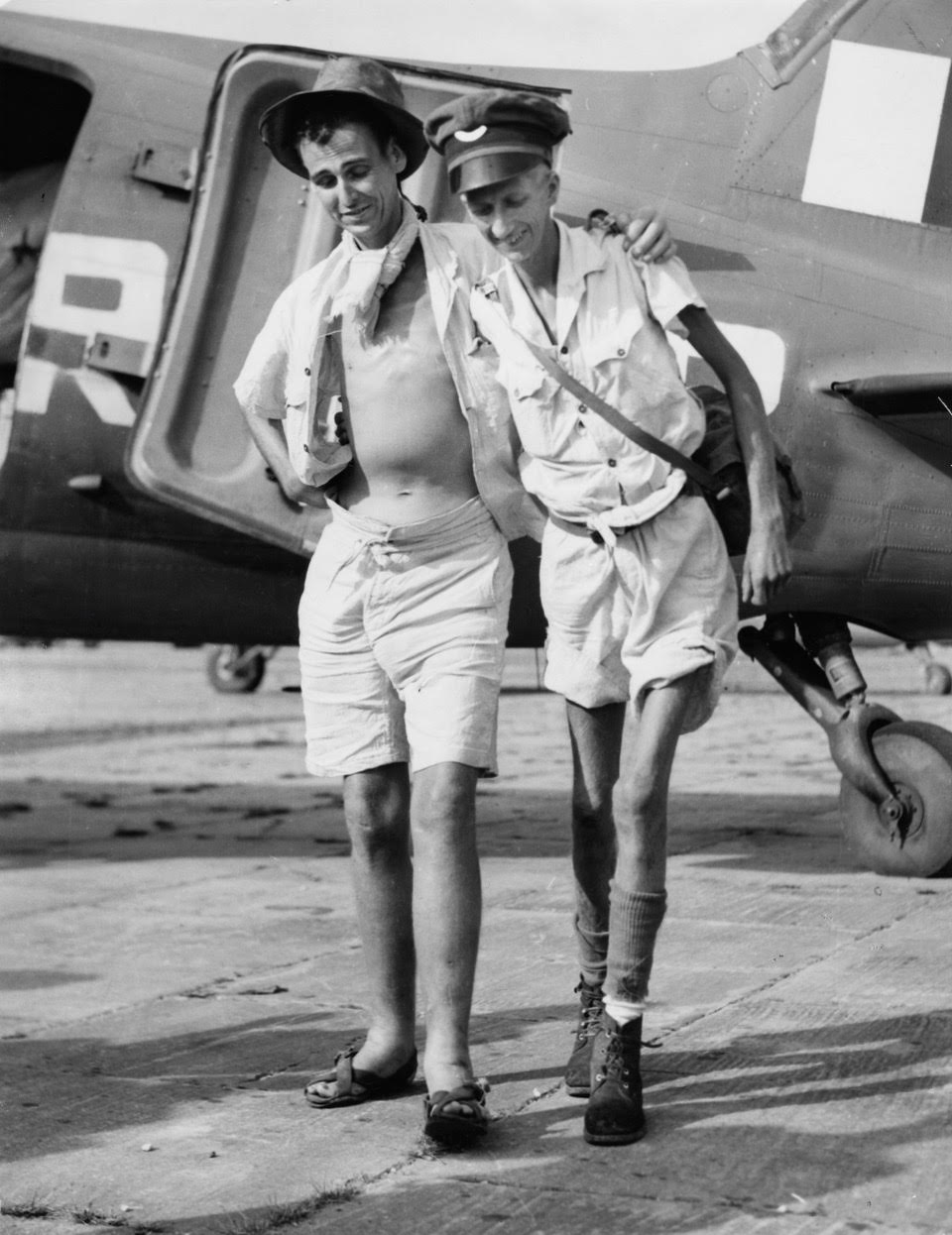 Keith (right) with George Coatsworth at Singapore civil airport; they’ve just stepped on to the tarmac following a flight from Sumatra where they had been POWs, 17 September 1945 