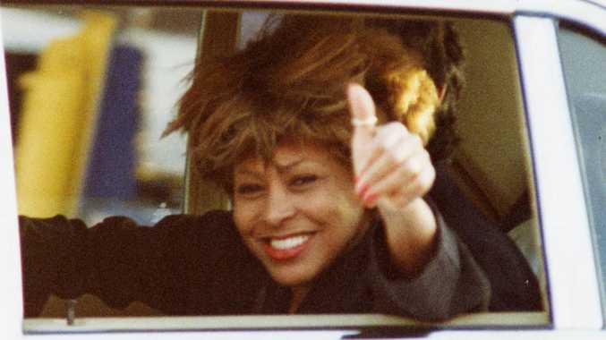 USA singer Tina Turner waves from a car as she arrives at Adelaide Airport for her concert to be given at the Australian Grand Prix, 06 Nov 1993.