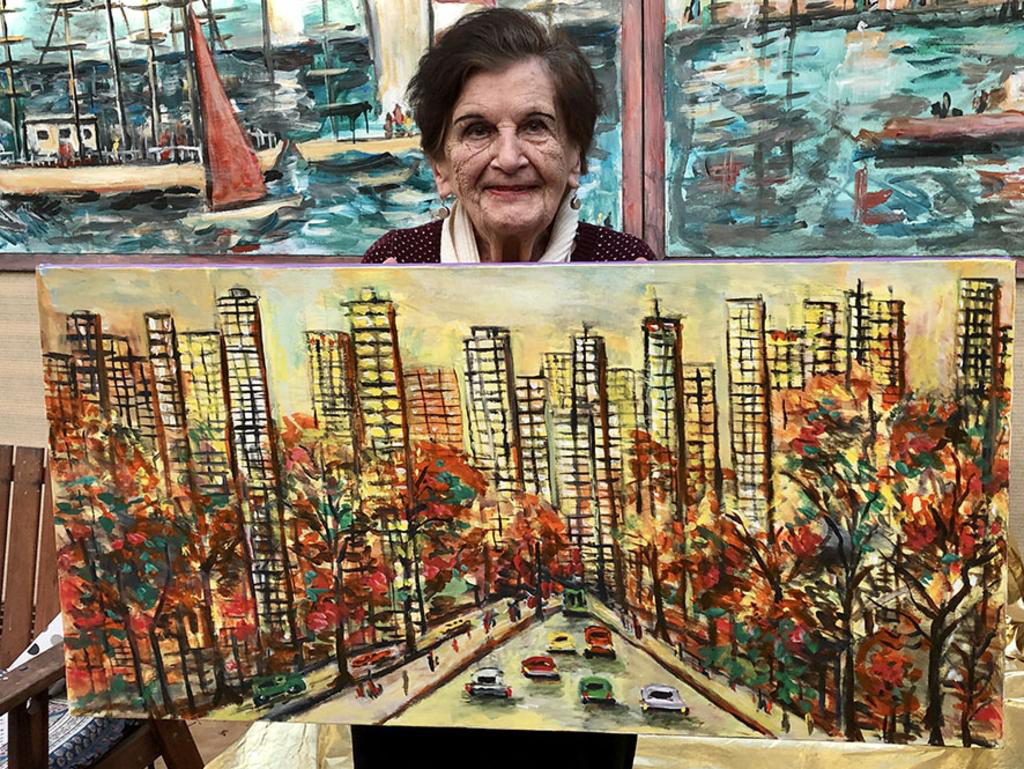 Marguerite Stark-Ebert with one of her many artworks. Her unique place-scapes and semi-abstracts accounted for most of her sales.