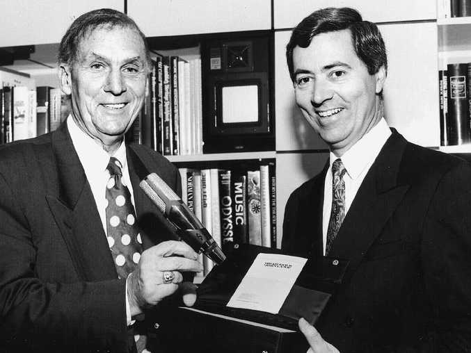 A moment in broadcasting history - John Laws receives his famous gold microphone in recognition of 50 years on air.